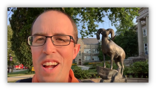 Person talking in front of a ram statue as an example of an on location video